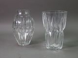 two glass vases sitting next to each other on a table