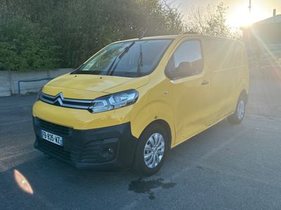 the yellow van is parked in a parking lot with the sun shining
