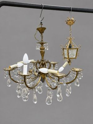 a chandelier hanging from a pole with a bird on it
