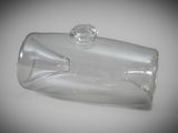 a clear glass bottle with a stopper sitting on a table