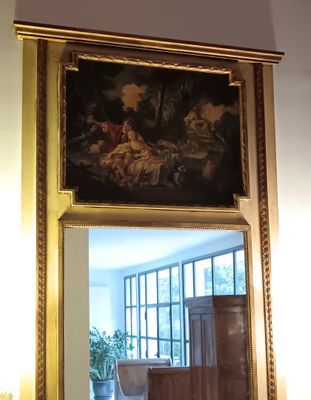a mirror with a painting on it in a room