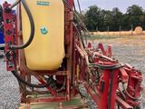 a close up of a tractor with a sprayer attached to it ' s back