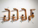 three wooden sconces mounted on the wall next to a lamp
