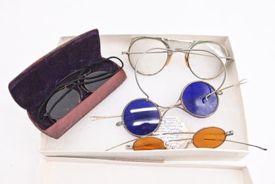two pairs of glasses and a case on the table