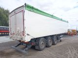 a white truck with a green top parked on the side of the road