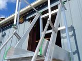a ladder that is sitting on the side of a building
