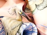 a woman with a bird painted on her body