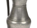 an old silver pitcher with a handle on a white background