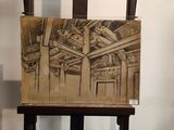 painting on a wooden easel in a room with a white wall