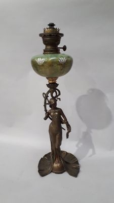 bronze and green vase with a woman holding a flower on it