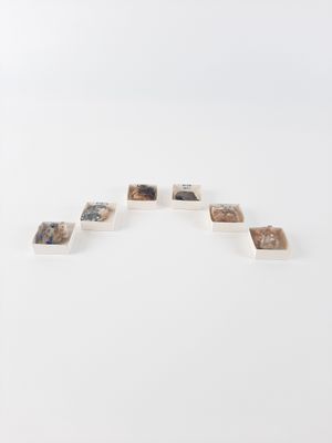 an image of a sculpture made out of rocks on a white surface