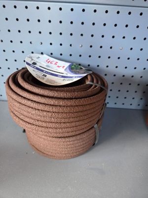 a stack of brown rope sitting on a shelf next to a pair of shoes