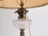 a lamp that is on a table with a lamp shade on it