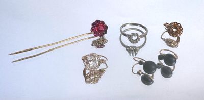 a lot of different rings and jewelry on a white surface