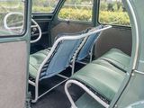 two seats in the back of a bus with a view of trees