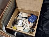 a wooden box filled with assorted items on a black cloth
