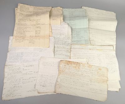 several old papers are stacked on top of each other on a table