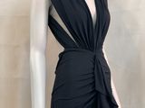 the mannequin is wearing a black dress with a knot around the waist