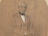 portrait of a man in a suit and bow tie sitting in a chair