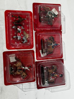 six plastic toy figures of knights and horses in red cases