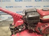 a red lawn mower that is sitting on the ground