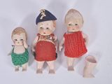 three small dolls that are sitting next to each other