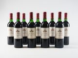 six bottles of red wine lined up in a row on a white surface