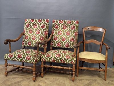 two wooden chairs sitting next to each other on top of a hard wood floor