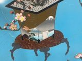 a blue plate with a picture of a deer and flowers on it