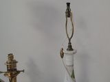 a lamp that is sitting on a table next to a clock
