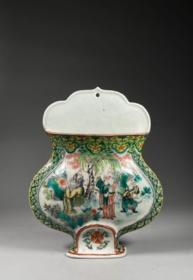 a white and green vase sitting on top of a table