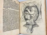 an old book with a drawing of a baby inside of it
