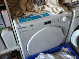 a washer and a dryer in a room with a tiled floor
