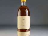 a bottle of wine sitting on top of a white table