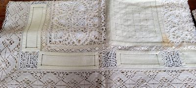four pieces of white lace on a table top