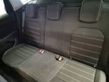 the back seats of a car with a cell phone in it