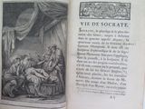 an open book with a picture of a man and a woman sitting on a bed