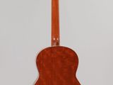 an acoustic guitar hanging on a wall