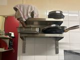 a man that is standing on top of a stove in a kitchen