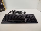 a black keyboard and a dvd on a white table