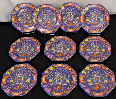 six colorful plates with designs on them on a black surface