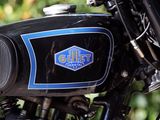 a close up of a motorcycle with a blue and black logo on it