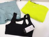 three pairs of sports bra tops and shorts are on a table