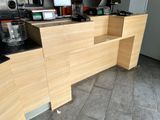 a wooden counter with a black counter top and a black counter top