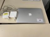 a laptop computer sitting on top of a desk next to a keyboard
