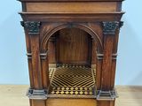 an old wooden fireplace with a tiled floor in a room