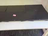 a desk with four laptops on top of it