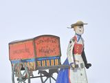 figurine of a woman pulling a wagon with a horse drawn carriage