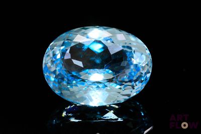 an image of a blue topazte gems on a black surface