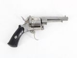 an old revolver on a white surface with a black handle